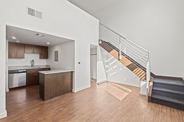 Denver apartment for rent - A kitchen with a refrigerator, sink, and cabinets is shown.