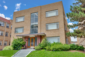 Denver apartment for rent - A building with a red roof and a glass door.