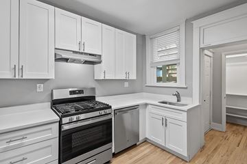 Denver apartment for rent - A modern kitchen with white cabinets and a stainless steel oven.