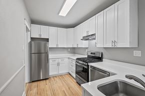 Denver apartment for rent - A kitchen with white cabinets and stainless steel appliances.