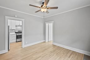 Denver apartment for rent - A room with a ceiling fan and a doorway leading to another room.