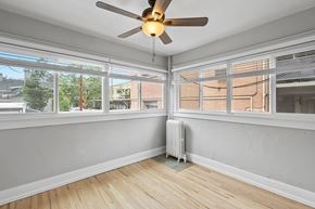 Denver apartment for rent - A room with a ceiling fan and a radiator on the floor.