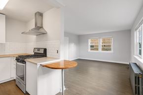 Denver apartment for rent - A kitchen with a stove top oven and a table.