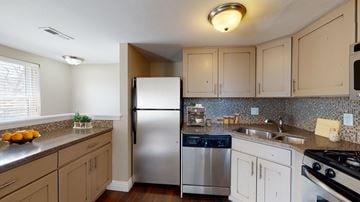 Denver apartment for rent - A kitchen with a refrigerator, stove, and sink.
