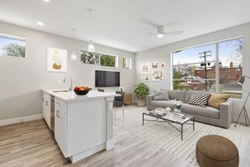 Denver apartment for rent - a living room with a couch and a table and a kitchen