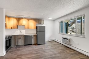 Denver apartment for rent - A kitchen with wooden cabinets and a stainless steel refrigerator.