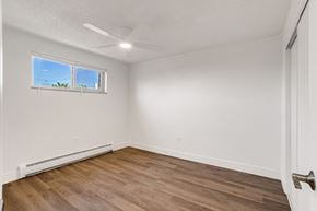 Denver apartment for rent - A room with a window and a ceiling fan.