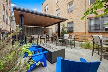 Denver apartment for rent - A patio with blue chairs and a table.