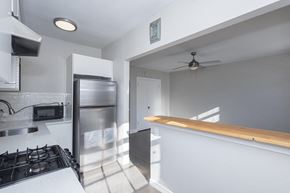 Denver apartment for rent - A modern kitchen with a stove top oven and a refrigerator.