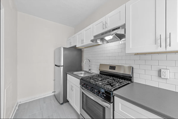Denver apartment for rent - a kitchen with stainless steel appliances and white cabinets