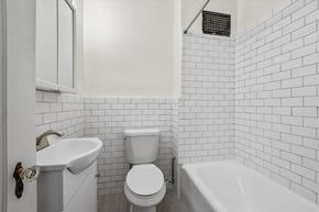 Denver apartment for rent - a white bathroom with a toilet and a sink