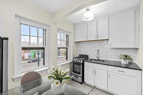 Denver apartment for rent - a white kitchen with a table and a window