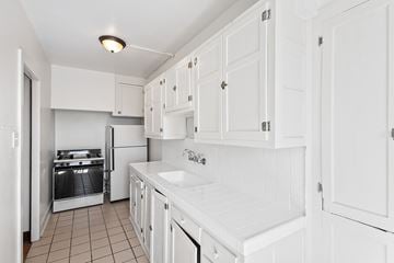 Denver apartment for rent - A kitchen with white cabinets and appliances.