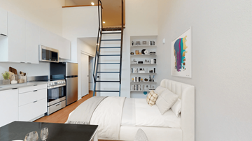 Denver apartment for rent - A modern kitchen with a staircase leading to the upper floor.
