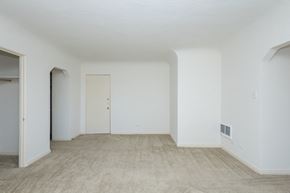 Denver apartment for rent - A room with a carpeted floor and a door.