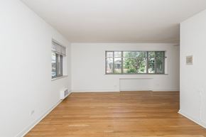 Denver apartment for rent - A room with wooden floors and a window.