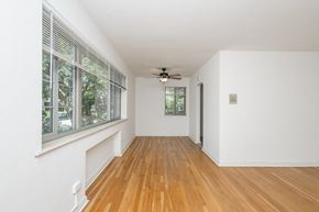 Denver apartment for rent - A room with a ceiling fan and wooden floors.