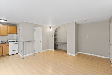 Denver apartment for rent - A kitchen area with a white stove and wooden cabinets.
