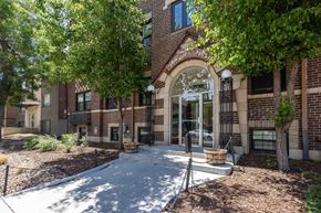 Denver apartment for rent - A brick building with a tree in front of it.