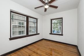 Denver apartment for rent - A room with a ceiling fan and two windows.