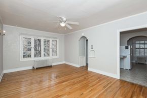 Denver apartment for rent - A room with a ceiling fan and a window with a view of a snowy landscape.