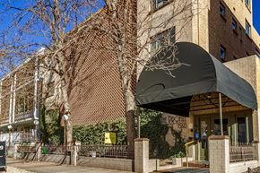 Denver apartment for rent - The entrance to a building with a black awning and a sign that reads "The Pro Hill".