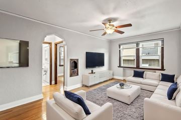 Denver apartment for rent - A living room with a white couch and a ceiling fan.