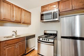 Denver apartment for rent - A kitchen with a stove, refrigerator, and microwave.