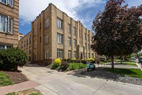 Denver apartment for rent - A large brick building with a tree in front of it.