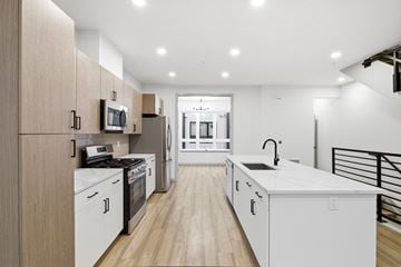 Denver townhouse for rent - A modern kitchen with wooden cabinets and white appliances.