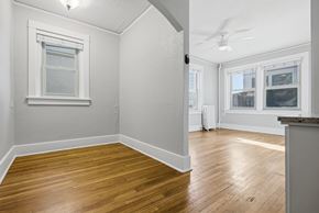 Denver apartment for rent - A room with wooden floors and white walls.