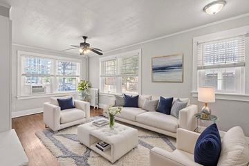 Denver apartment for rent - A living room with white furniture and a ceiling fan.