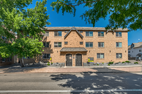 Denver apartment for rent - A brick building with a black door and windows.