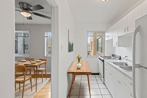 Denver apartment for rent - A kitchen with a table and chairs in the middle of the room.