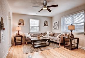 Denver apartment for rent - A living room with a couch, two end tables, and a ceiling fan.