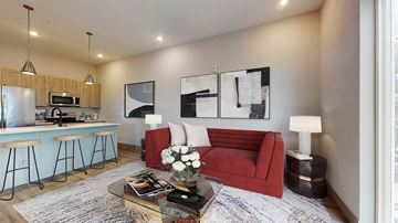Denver apartment for rent - A modern living room with a red couch and a coffee table.
