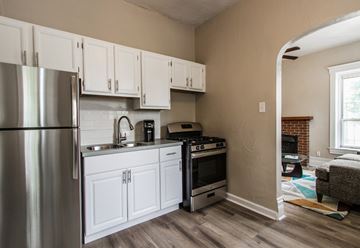 Denver apartment for rent - A kitchen with white cabinets and a stainless steel refrigerator.