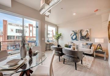 Denver apartment for rent - A modern living room with a glass table and chairs.