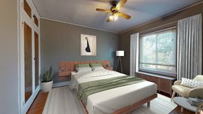 Denver apartment for rent - A bedroom with a bed, a chair, and a ceiling fan.