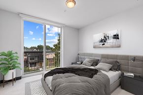 Denver apartment for rent - a bedroom with a bed and a large window