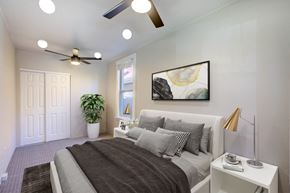 Denver apartment for rent - a bedroom with a bed and a ceiling fan