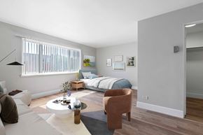 Glendale apartment for rent - a bedroom with a bed and a living room with a table and chairs