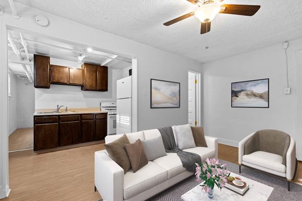 Denver apartment for rent - A living room with a white couch and a ceiling fan.