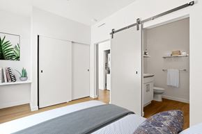 Denver apartment for rent - a bedroom with white walls and wood floors