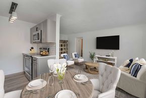 Denver apartment for rent - A modern dining room with a wooden table set for two.
