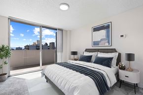 Denver apartment for rent - a bedroom with a bed and a large window