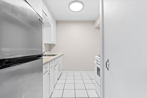 Denver apartment for rent - A kitchen with white cabinets and appliances.