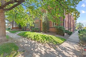 Denver apartment for rent - a sidewalk in front of a brick building with green grass
