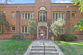 Denver apartment for rent - the front of a brick building with a red door