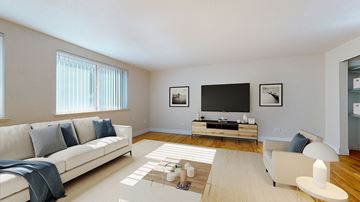 Denver apartment for rent - A living room with a white couch and a television.